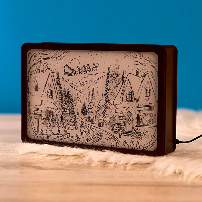 Christmas Night Light Box switched off, engraved snowy village and Santa sleigh outline