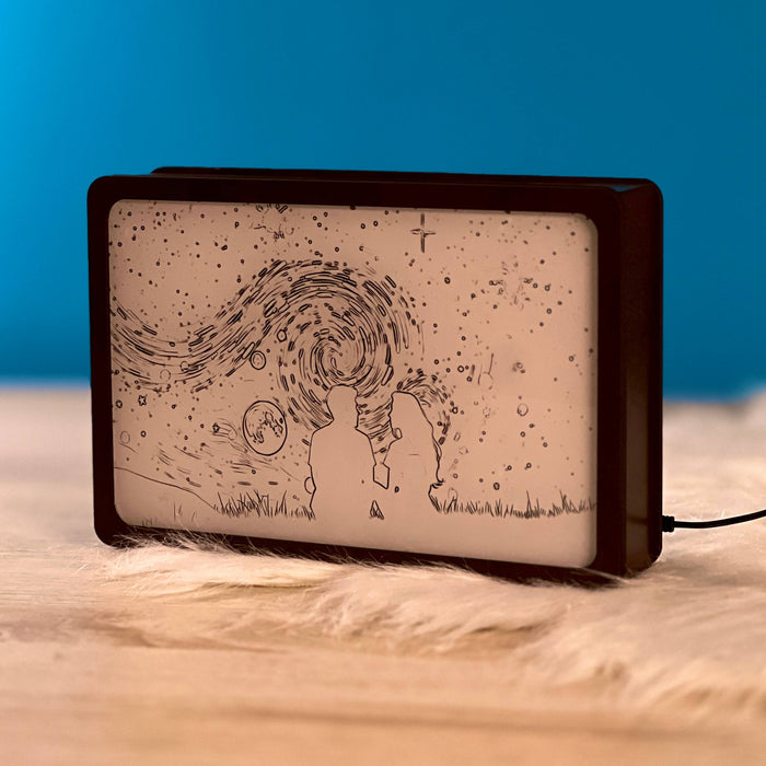 Lovers Moon Night Light Box switched off, engraved couple under a swirling starry sky