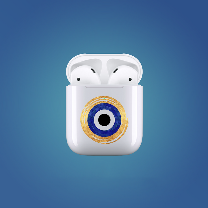 White wireless earbud case with a decorative eye design on a blue background