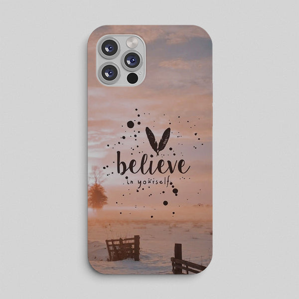 Phone case with sunset design and 'believe in yourself' text on a light gray background