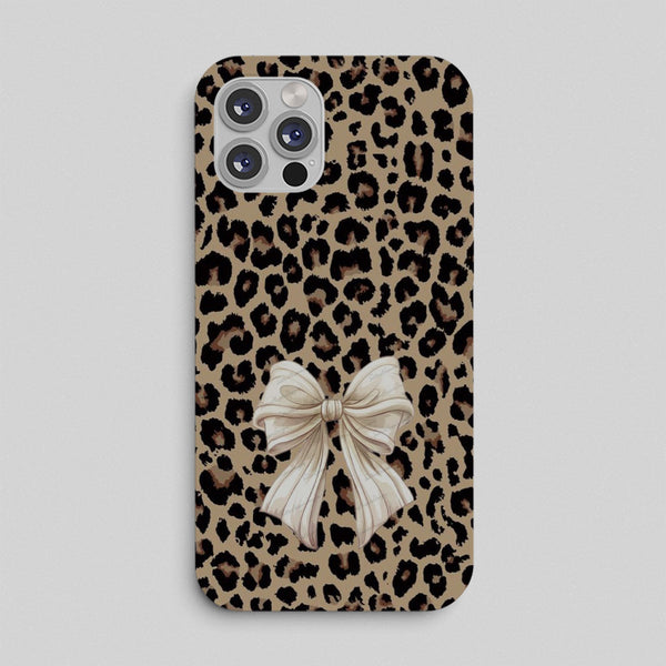 Phone case with leopard print pattern and a bow design on a light gray background