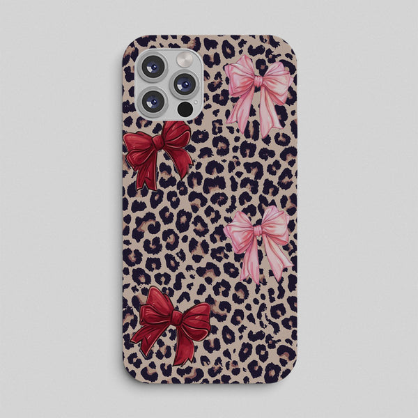 Phone case with leopard print and colorful bows on a light gray background