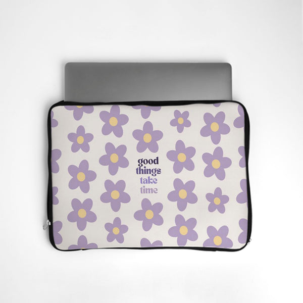 Laptop sleeve with purple floral pattern and 'good things take time' text on a white background bunny store
