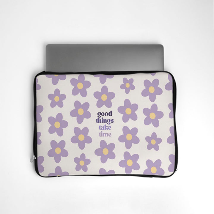 Laptop sleeve with purple floral pattern and 'good things take time' text on a white background bunny store