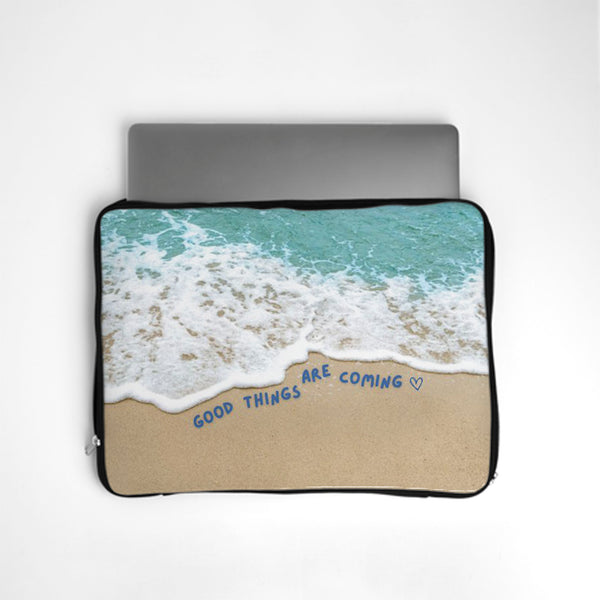 Laptop sleeve with beach design and 'Good things are coming' text on a white background bunny store