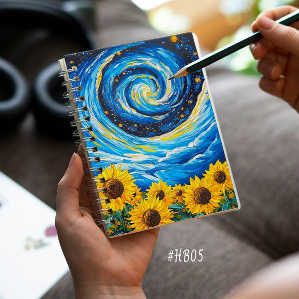 Person holding a notebook with a sunflower design and a pen, blurred background