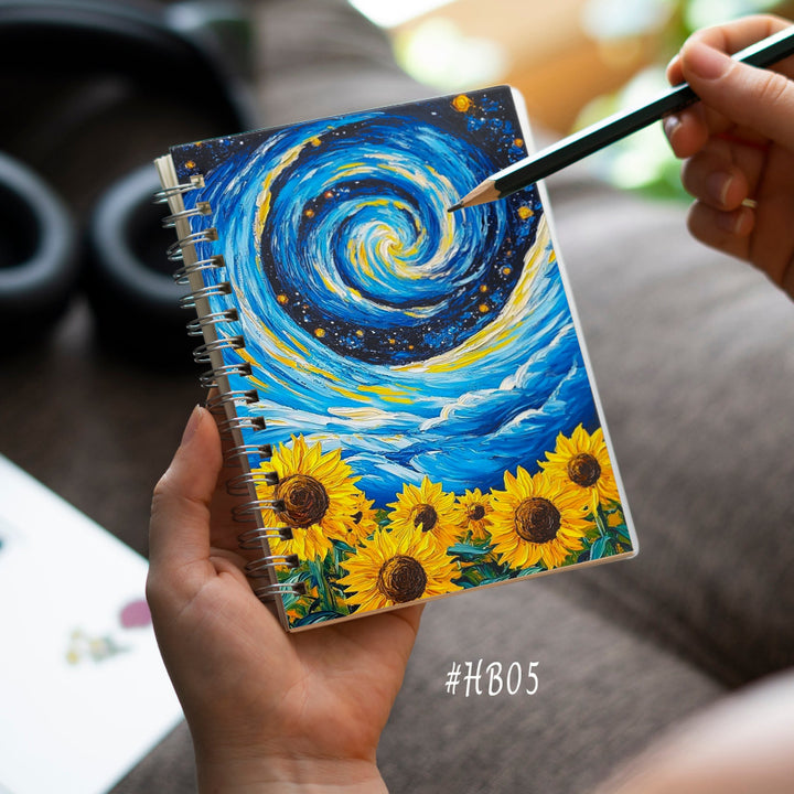 Person holding a notebook with a sunflower design and a pen, blurred background
