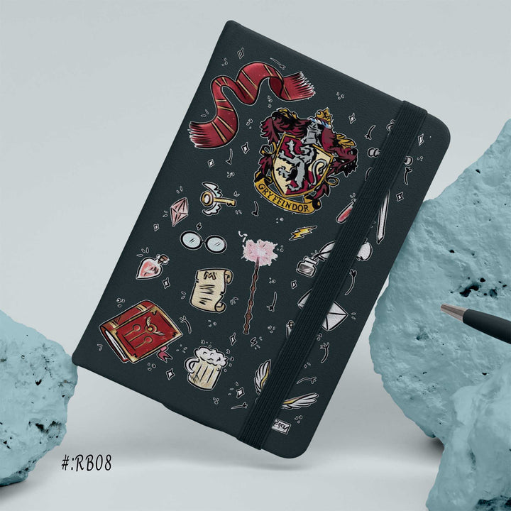 Hardcover notebook with Gryffindor crest and Harry Potter inspired doodles on a black cover, including scarf, wand, glasses, and magical items bunny store

