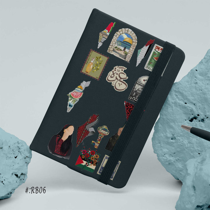 Hardcover notebook with black cover decorated in Palestine-themed stickers, maps, Arabic calligraphy, landmarks, and cultural symbols bunny store