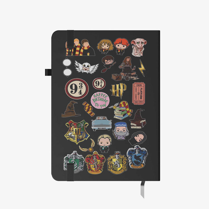 Hardcover notebook with black cover decorated in Harry Potter themed stickers, including house crests, characters, and magical icons