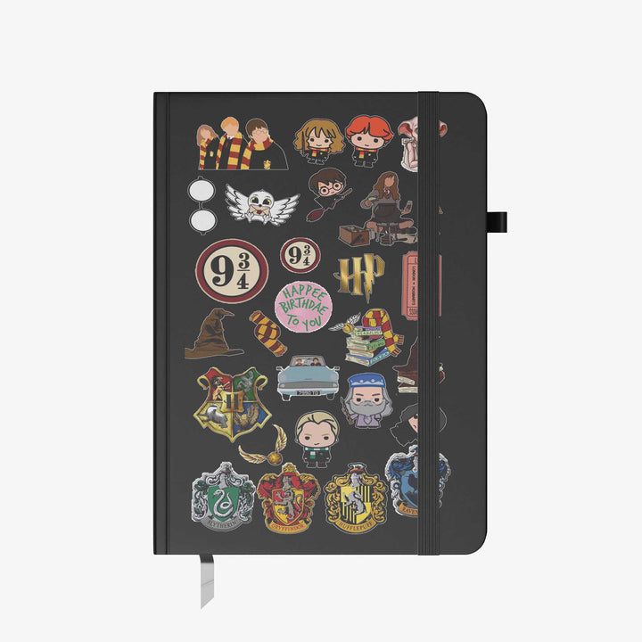 Hardcover notebook with black cover decorated in Harry Potter themed stickers, including house crests, characters, and magical icons