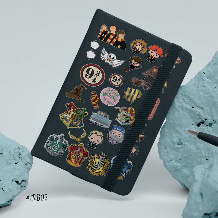Hardcover notebook with black cover decorated in Harry Potter themed stickers, including house crests, characters, and magical icons