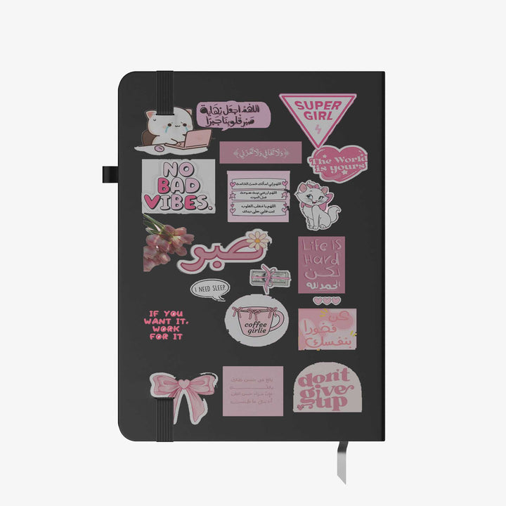 Hardcover notebook with black cover decorated in pink motivational stickers, Arabic and English quotes, and cute graphics bunny store